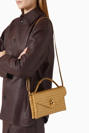 حقيبة كروس بقفل على شكل عقدة جلد بيكولو لامع مجدول