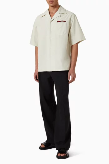 قميص بياقة بطية وشعار الماركة