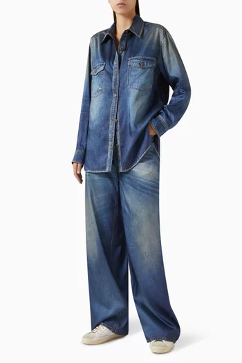 بنطال جينز ميلودي بقصة ساق واسعة وتفاصيل ممزقة