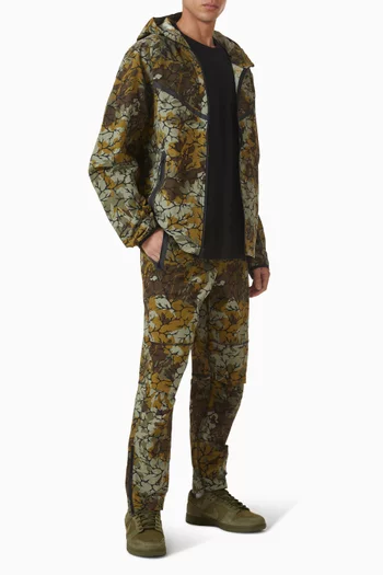 بنطال تيك بحواف مفتوحة ومعالج بتقنية Dri-FIT قماش منسوج